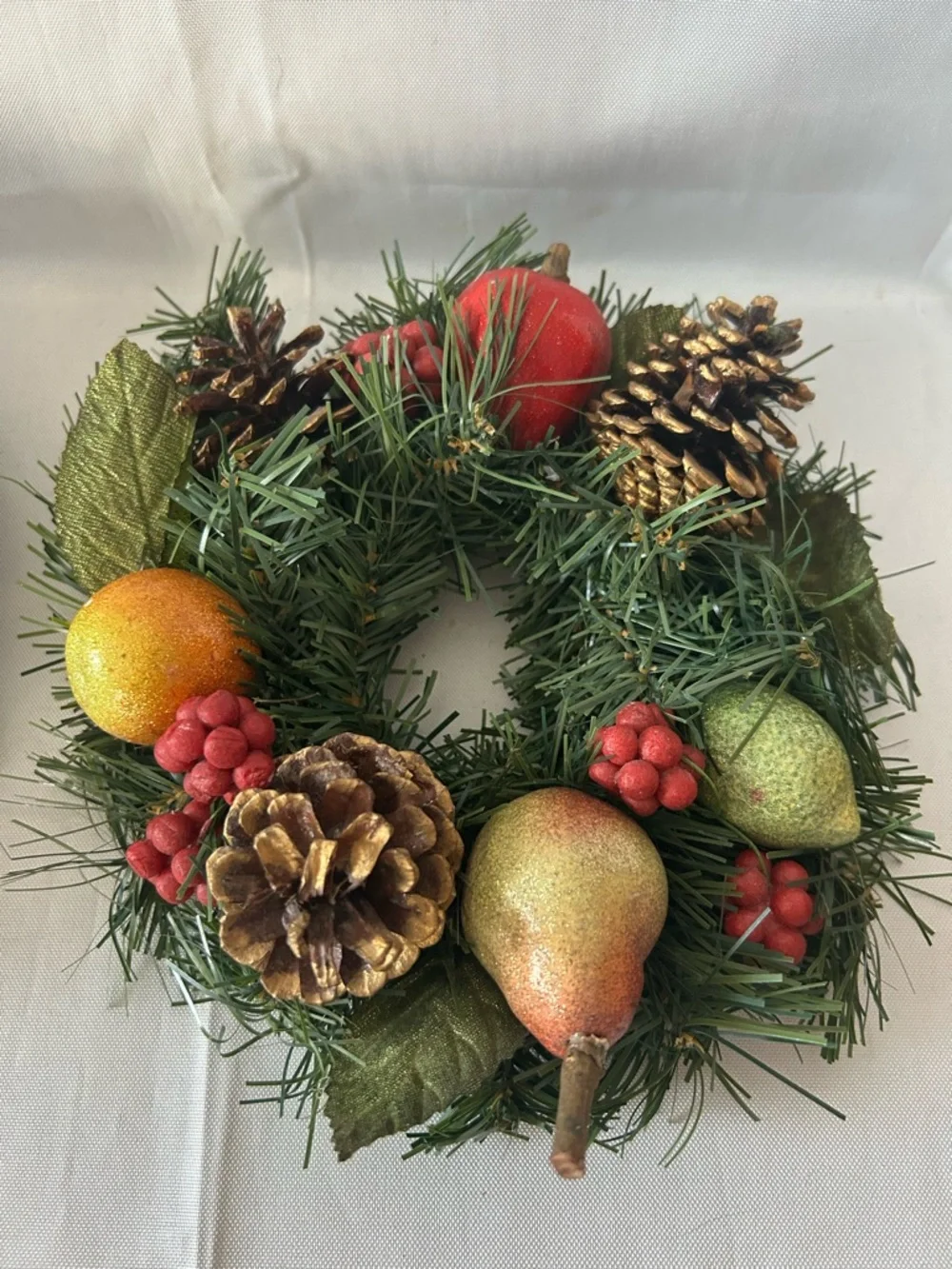 VTG artificial wreath/candle ring w/faux fruit, pinecones, and red berries.